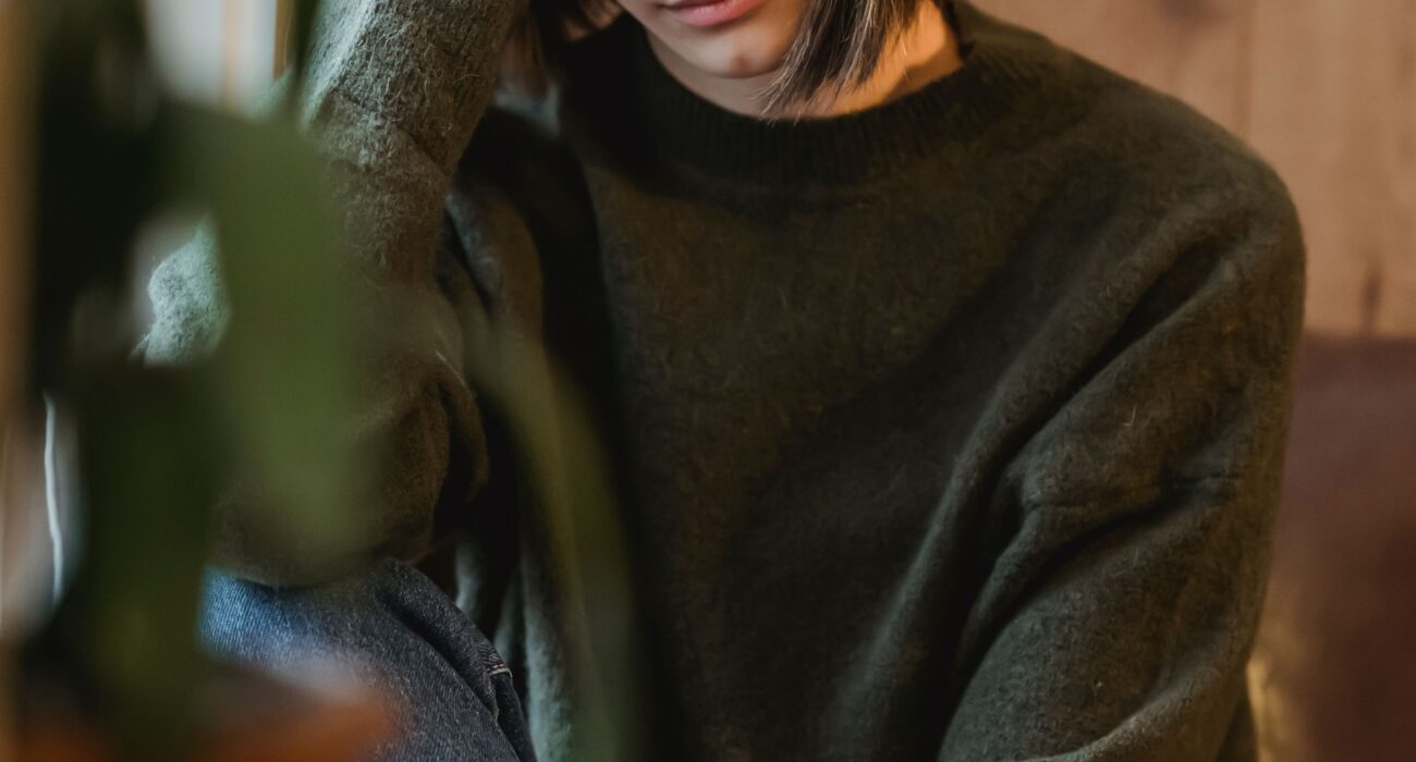 A woman taking a peaceful, quiet break by a window at home, representing the rest and recharge time respite care provides for family caregivers